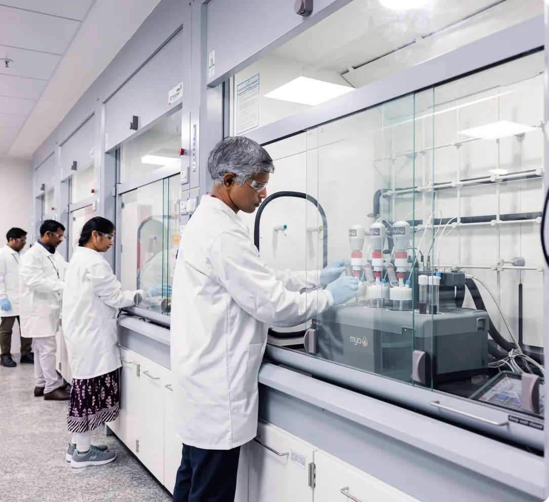 Scientist performing route scouting to optimize chemical synthesis pathways