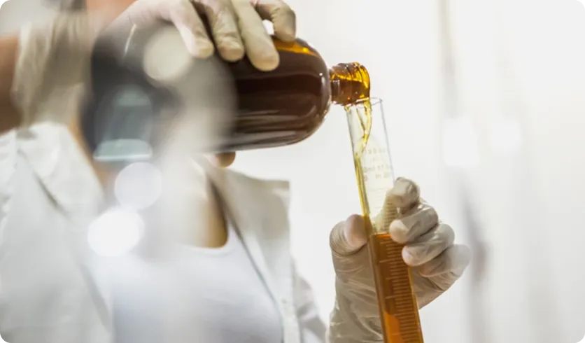 A scientist handling a test tube in a pharmaceutical lab, symbolizing Honour’s expertise in pharmaceutical ingredients